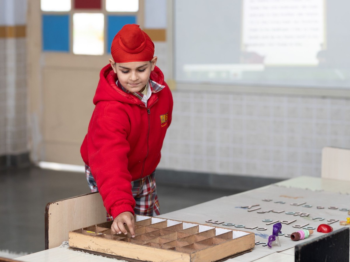 Child learning through Montessori classroom materials