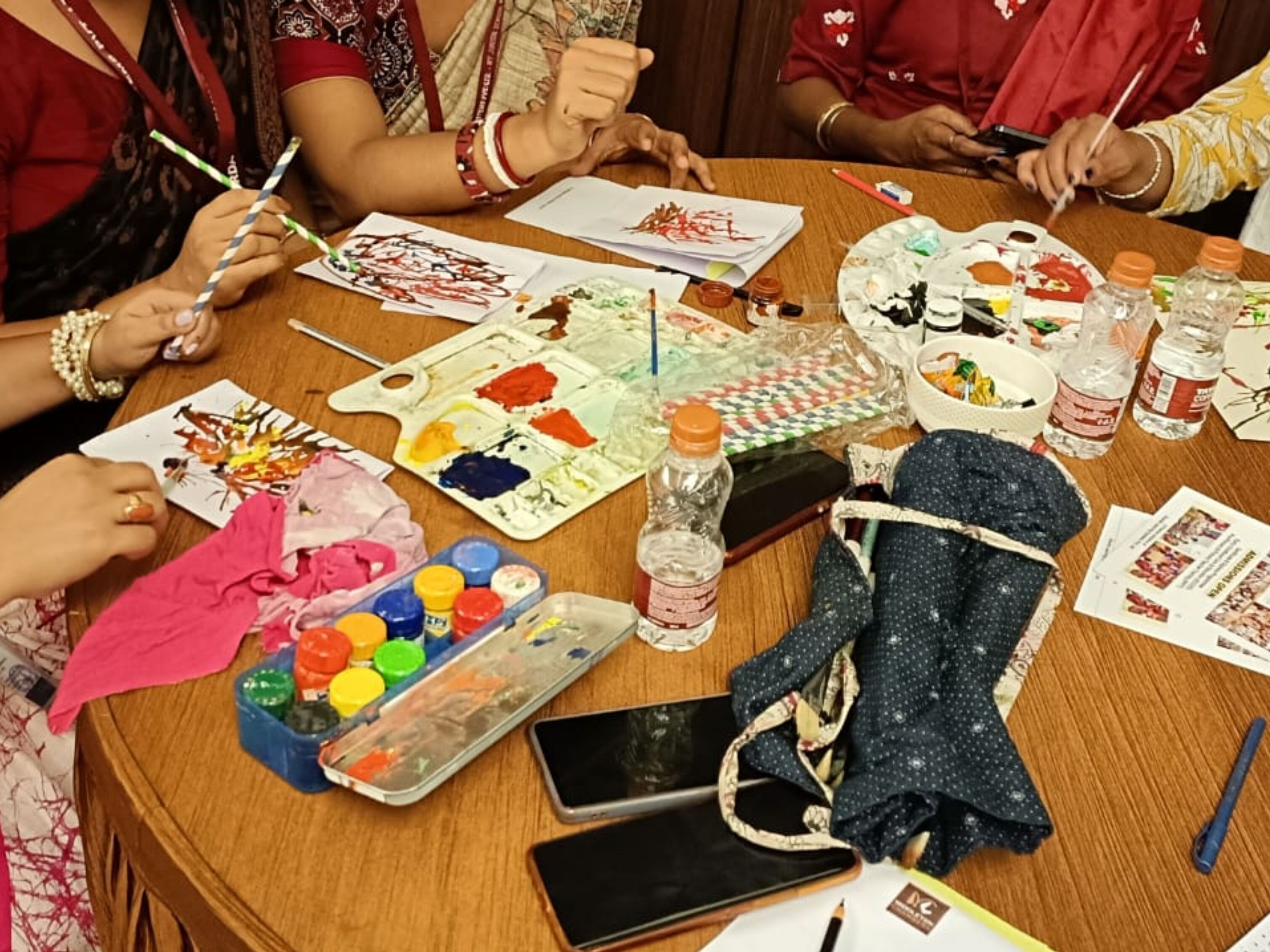 Teacher guiding a child during a classroom craft activity
